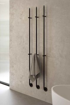 two towel racks are hanging on the wall