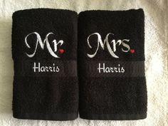 two black towels with the words mr and mrs on them are sitting next to each other