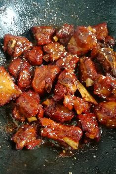 some food is cooking in a wok on the stove top and ready to be eaten