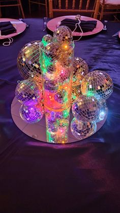 disco ball centerpieces on a purple table cloth