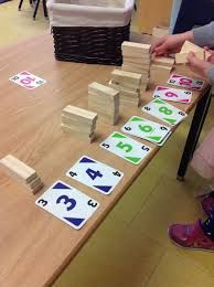 a child playing with wooden blocks and numbers