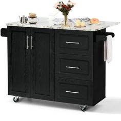 a kitchen island cart with marble top and drawers on casteors for wheels, black