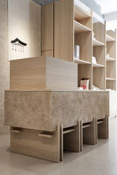 the counter is made out of wood and has drawers on each side, along with shelving