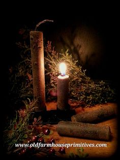 a candle is lit in the dark surrounded by herbs and other things to decorate it