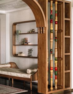 an arch in a living room filled with furniture and decorating items that include bookshelves