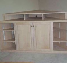 an empty room with some shelves and cupboards on the floor in front of it