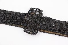 Antique vintage Victorian belt. This belt was made in the late 1800s. It was made out of jet black, glass beads for mourning purposes. The belt has a hook closure. Great for Victorian/Edwardian collectors or to carefully wear.  In good vintage condition. Shows signs of wear from age and use, such as discoloration, scratches, stains and other markings. Some beads have or are falling off and there are rust markings on the hook. The belt measures 27" (not including the buckle). Message me with any Victorian Belt, Belt Vintage, Beaded Belt, Vintage Victorian, Suspender Belt, Antique Victorian, Black Glass, Black Belt, Jet Black