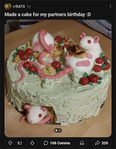 a cake that has been decorated with mice and cherries on the top is white frosting