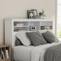 a bedroom with a bed, bookcases and pictures on the wall above it