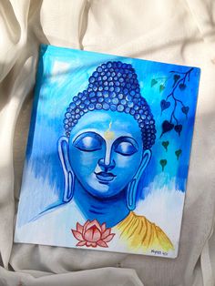 a painting of a buddha face on a white sheet