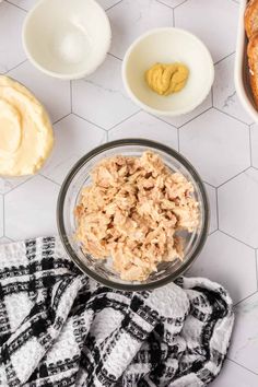 the ingredients to make peanut butter and jelly bread laid out on a marble counter top