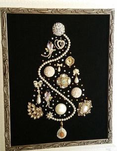 a christmas tree made out of pearls and other ornaments on a black background with gold trim