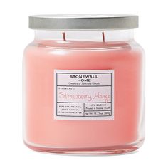 a pink candle with a metal lid and label on the front that says stonewall home