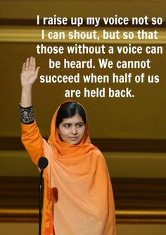 a woman in an orange shawl is holding her hand up to the sky and saying, i raise up my voice not so i can shut but so that those without a voice can be heard