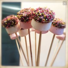 there are five cake pops with sprinkles on them