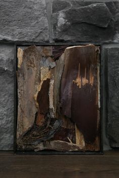 a piece of wood that has been split in half on top of a stone wall