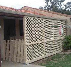 a white fence sitting next to a house