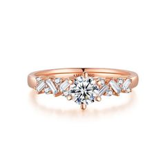 a rose gold engagement ring with three baguets on the side and an arrow shaped diamond