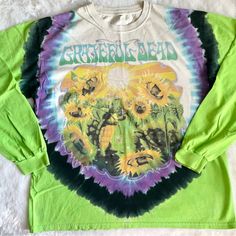 Vintage 1998 Grateful Dead Terrapin Station Sunflower Turtle Sun And Moon Long Sleeve Tshirt, Rare To Find In A Long Sleeve. Super Dope And In Great Condition For Its Age. Small Hole On The Back Neck Line As Shown In The Last Photos, As Well As Some Bleach Stains Along The Sleeves As Shown. Still Lots Of Life Left. No Size Tag, Would Fit Xs-Xl Depending On Desired Fit. Please See The Measurements Provided Below Before Purchasing. Price On This Is Firm! Pit To Pit- 24” Length- 28” Sunflower Turtle, Terrapin Station, Terrapin, Grateful Dead, Sun And Moon, Vintage Tshirts, Green And Purple, Size Tag, Blue Man