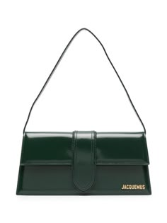 Find JACQUEMUS Le Bambino Shoulder Bag on Editorialist. The Jacquemus le bambino shoulder bag is crafted from calf leather and features a smooth grain, gold-tone logo lettering, and a rectangle shape. It has a foldover top with a magnetic fastening, a single shoulder strap, a main compartment, an internal logo patch, an internal slip pocket, and a cotton lining. This bag has gold-tone hardware and comes complete with a protective dust bag. Green Luxury Bag, Green Designer Bag, Dark Green Purse, Green Bag Outfit, Jacquemus Le Bambino Long, Jacquemus Bags, Green Shoulder Bag, Jacquemus Bag, Expensive Bag