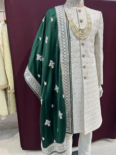 a mannequin dressed in green and white clothing