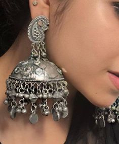 Add charm and charisma to your beautiful personality with these exquisitely designed and handcrafted high quality earrings in antique silver look.Pair them up with any formal or semi formal attire and gather compliments wherever you go. Suitable for both casual and dressy occasions.Each earring weighs only 30 GM's (lightweight)Length 3.8 inches Light weight*****************************************Note: All in stock items will be shipped from New Delhi, India within 2-3 business days after receip Bohemian Brass Jhumkas For Weddings, Traditional Silver Earrings With Bells, Bohemian Brass Chandbalis For Festive Occasions, Traditional Silver Bell Earrings, Metal Chandbali Jhumkas With Intricate Design, Vintage Chandbali Jhumkas With Latkans, Vintage Chandbali Jhumkas For Festivals, Handmade Silver Metal Jhumkas, Ornate Brass Chandbali Jhumkas