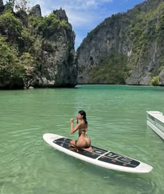 a woman sitting on top of a surfboard in the ocean