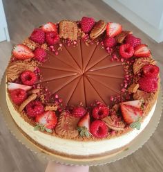 a cake with chocolate frosting and strawberries in the shape of a sunburst