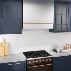 a stove top oven sitting inside of a kitchen next to blue cabinets and counter tops