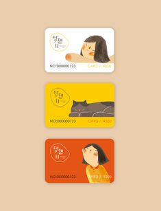 three credit cards, one with a woman's face and the other with a cat