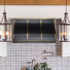 Ogee shaped black stainless steel range hood under cabinet mounted with antique style and brass decorations Black Vent Hood, Black Stainless Range Hood, Range Hood Covers, Black Range Hood, Range Hood Cover, Steel Range Hood, Stainless Range Hood, Hood Cover, Under Cabinet Range Hood