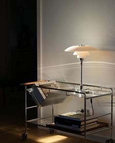 a table lamp sitting on top of a metal shelf