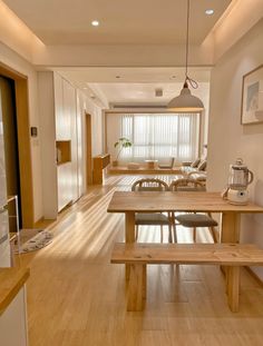 a dining room table and benches in front of a window