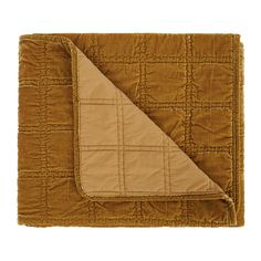 a brown blanket with a tan quilt on it and a beige square in the middle