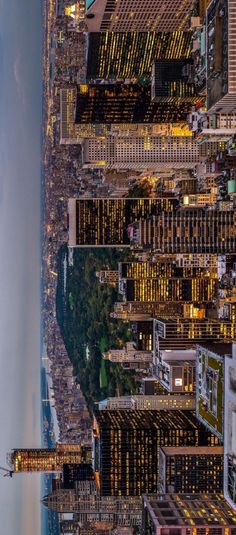 an aerial view of the city at night from above, looking down on skyscrapers