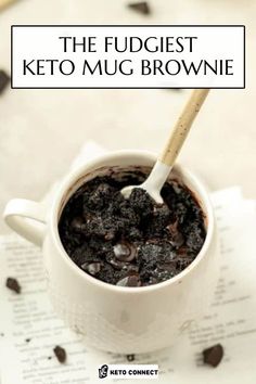 the fudget keto mug brownie is in a white cup with a spoon