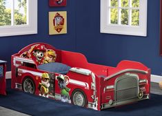 a child's bed with a fire truck theme and paw patrol characters on it