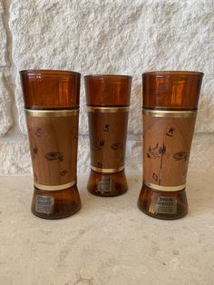 three wooden cups sitting next to each other