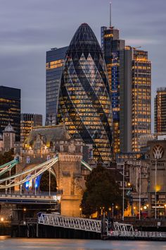 the city skyline is lit up at night, with skyscrapers in the back ground