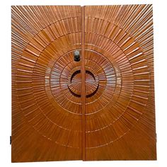 a wooden door with an intricate design on the front and side panels that are made out of bamboo