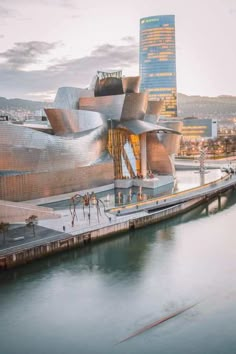 a large building sitting next to a body of water