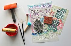 some crafting supplies are laying out on a white surface with scissors and other items