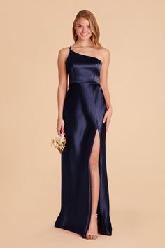 a bridesmaid in a blue gown with one - shoulder and slited skirt