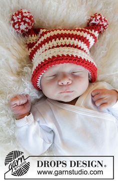 a newborn baby wearing a red and white hat