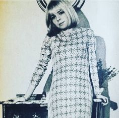 an old photo of a woman standing in front of a record player with her arms outstretched