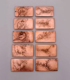 six wooden plaques with different drawings on them