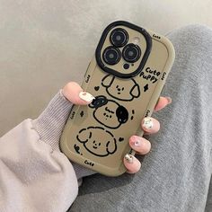 a woman holding up her phone case with a cartoon dog on the front and side