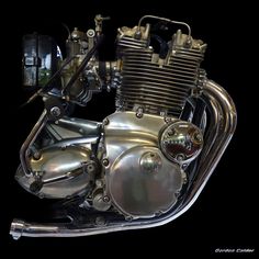 the motorcycle engine is shiny and chromed on black background with clipping for text