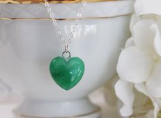 "Sweet genuine green jade heart , the heart is 3D. Hangs from a fine sterling silver cable chain with a spring clasp closure. Great gift for a love one . The model is wearing 16: length Jade is the mystical birthstone for March birthdays Jade carries a sweet, light and nourishing energy that can feel very healing. It has a soothing purity about it, and it goes about purifying your energy field in a very accepting, loving, and wise kind of way. So, one obvious meaning of the jade stone is purity March Birthdays, Water Mill, Green Heart, Necklace Green, Jade Necklace, Energy Field, Jade Stone, Layering Necklace, Green Necklace