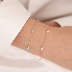 With this 14k Gold White, Light Blue, and Dark Blue Opal Round Bracelets, you may explore the fascinating world of opals. Choose from three opal colors: white opal's purity, light blue opal's tranquillity, or dark blue opal's depth. Each opal reflects the spirit of October's birthstone, making it a lovely gift for Libras or anybody born in this month. Opals are associated with Venus, the goddess of love and beauty, making this bracelet a symbol of appeal and elegance. Whether you choose the soot Fine Jewelry Blue Gold Bracelet For Gift, Blue Gold Bracelet For Gift, Fine Jewelry, Blue Gold Bracelet For Gifts, Blue Gold Bracelet With 17 Jewels For Gift, Blue Dainty Birthstone Bracelets, Dainty Blue Bracelets For Wedding, Blue Bracelet Jewelry For Birthday, Blue Birthstone Bracelets In Fine Jewelry Style, Blue Birthstone Bracelets Fine Jewelry